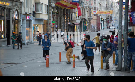 Istanbul, Turquie -- les civils, les protestataires, exécuté à partir de gaz lacrymogènes et de canons à eau haute pression tandis que la police agit sans discernement, d'essayer d'empêcher les gens d'entrer dans la place, et l'arrestation de nombreux, au hasard. Juillet, 07, 2013. Photo par Bikem Ekberzade Banque D'Images