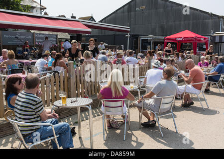 Whitstable , UK - Juillet 7th, 2013 : les habitants et les touristes profiter du soleil dans le port Graden cafe situé dans le port de Whitstable, Kent. Credit : CBCK-Christine/Alamy Live News Banque D'Images