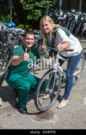 Mécanicien Vélo et client dans bike store showing Thumbs up Banque D'Images