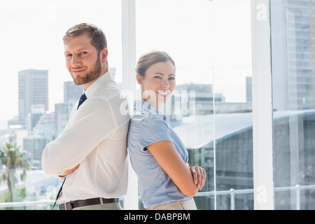 Happy business team standing back to back Banque D'Images