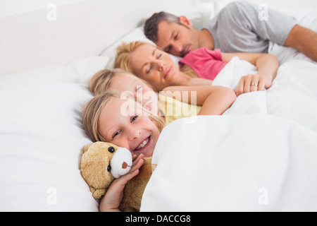 Les parents dormir avec leurs filles dans le lit Banque D'Images