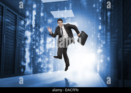 Businessman jumping in a corridor Banque D'Images