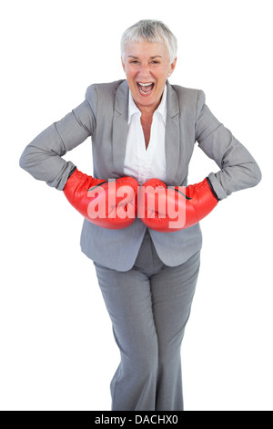 Happy businesswoman wearing boxing gloves Banque D'Images