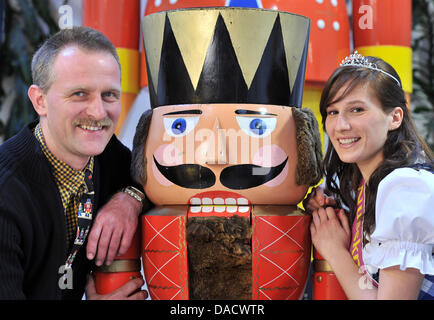 Casse-noisette en cours la reine Maria Fritzsche et propriétaire de la nutcracker museum Neuhausen, Uwe Loeschner, posent avec une immense pièce Casse-noisette à Neuhausen, Allemagne, 08 décembre 2011. La première nutcracker Museum de l'Europe montre la plus grande collection de casse-noix dans le monde ainsi que le plus grand et le plus petit Casse-noisette. Photo : Hendrik Schmidt Banque D'Images