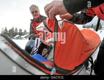 Les membres d'un service de secours en montagne de la Croix-Rouge allemande (DRK) sont illustrés au cours d'un exercice de sauvetage à une pente de ski à Oberwiesenthal, Allemagne, le 19 décembre 2011. Le service de sauvetage en montagne fait face à quelque 550 opérations de sauvetage par saison. Les skieurs et planchistes surtout besoin de l'aide du service. Photo : Hendrik Schmidt Banque D'Images