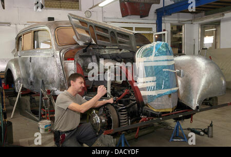 Mécanicien automobile Peter Spillner travaille sur la caisse d'une Mercedes-Benz 770 de 1941 dans son atelier de Glienick, Allemagne, 23 novembre 2011. La société est spécialisée dans la restauration de véhicules historcial. Photo : Nestor Bachmann Banque D'Images