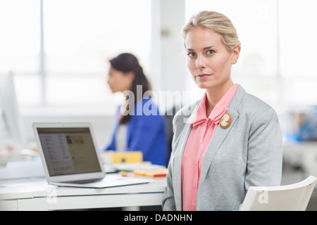 Young businesswoman at desk in office, portrait Banque D'Images