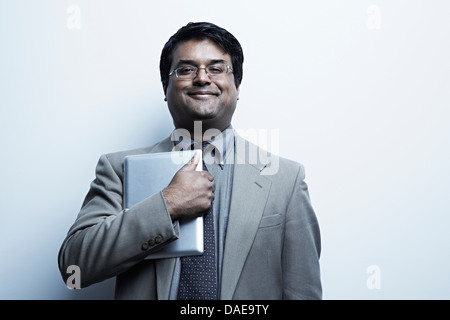 Studio portrait of businessman holding digital tablet Banque D'Images