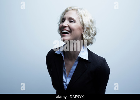 Studio portrait of businesswoman laughing Banque D'Images