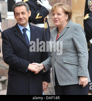 Le président français Nicolas Sarkozy (L), serre la main avec la Chancelière allemande Angela Merkel à Strasbourg, France, 24 novembre 2011. Le président français Nicolas Sarkozy, la chancelière allemande Angela Merkel et le premier ministre Mario Monti rencontrez pour des entretiens sur la situation financière de la zone euro. Photo : Rolf Haid Banque D'Images