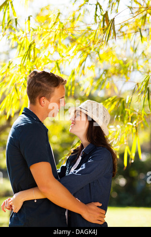 Young woman hugging outdoors in forest Banque D'Images