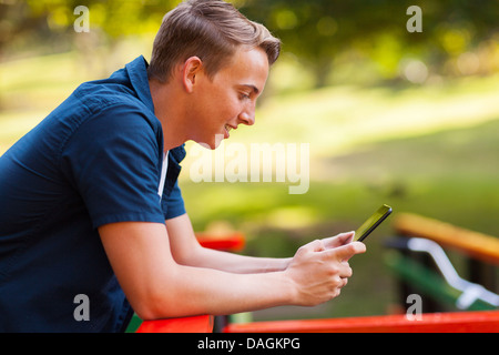 Cute girl using tablet computer outdoors Banque D'Images