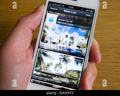 En utilisant Airbnb app de réserver hébergement de vacances sur un smartphone iPhone 5 Banque D'Images
