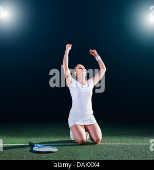 Tennis player cheering on court