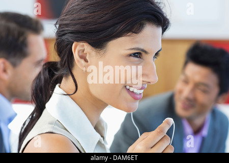 Businesswoman talking on headset in office Banque D'Images