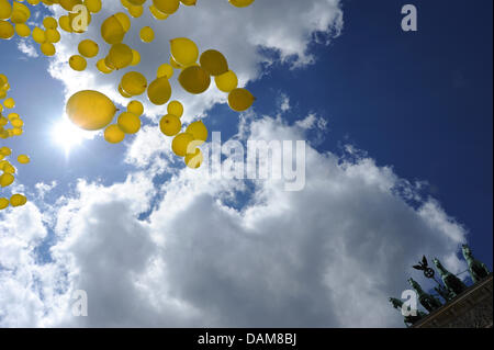 Ballon jaune montée dans le ciel au-dessus de la Pariser Platz en face de la porte de Brandebourg à Berlin, Allemagne, 28 mai 2011. L'organisation de défense des droits humains Amnesty International célèbre le 50e anniversaire de sa fondation le 28 mai 2011 et le rassemblement à la porte de Brandebourg est l'ouverture d'action autour de 200 grands et petits événements qui auront lieu au cours de l'ensemble de l'année en allemand Banque D'Images