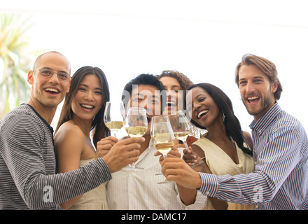 Friends toasting each other at party Banque D'Images