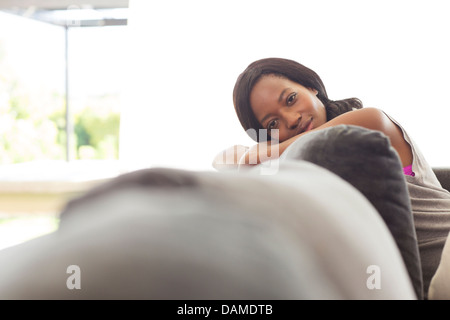 Woman relaxing on sofa Banque D'Images