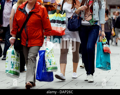 Les femmes marcher le long de la zone piétonne avec des sacs de shopping à Cologne, Allemagne, 20 juillet 2011. Vente d'été a commencé en Allemagne et les clients peuvent s'attendre à ce que 70 pour cent dicounts sur les biens de consommation dans les magasins. Photo : Oliver Berg Banque D'Images