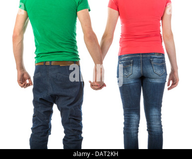 Young couple holding hands vu de dos sur fond blanc Banque D'Images