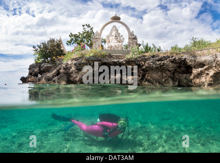 Duplex vue du plongeur sous-marin explorant blonde aux côtés d'île tropicale, temple en arrière-plan Banque D'Images