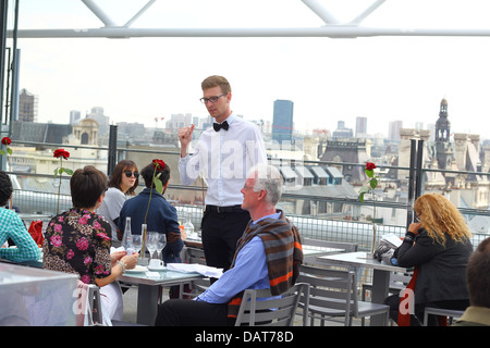 Parler aux clients serveur dans la fantaisie d'un restaurant sur le toit au 6e étage du centre George Pompidou (musée d'art moderne), Paris Banque D'Images