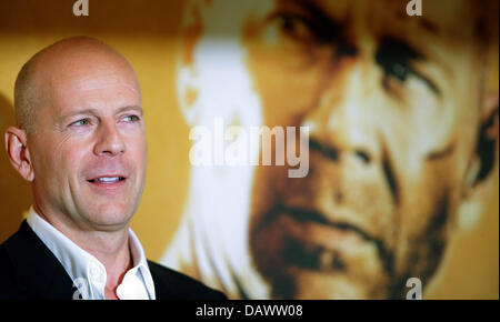 L'acteur américain Bruce Willis pose à la photo pour la prochaine première de son nouveau film "tirb langsam 4.0' ('Live Free or Die Hard') en face d'une affiche du film lui-même à Berlin, 18 juin 2007. Langsam tirb '4.0' sera affiché dans les salles allemandes du 27 juin 2007. Photo : Johannes Eisele Banque D'Images