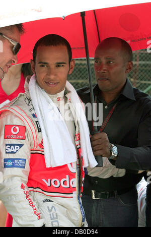 Le pilote de Formule 1 britannique Lewis Hamilton (C) de McLaren Mercedes se prépare avec son père Anthony (R) pour la Formule Un Grand Prix de Hongrie sur le Hungaroring race track près de Budapest, Hongrie, 05 août 2007. Hamilton a remporté la course en avant de runner-up Raikkonen et Heidfeld placé troisième. Photo : Carmen Jaspersen Banque D'Images