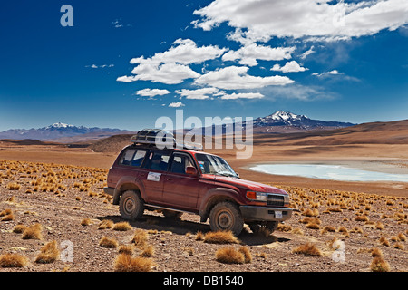 4x4 sur la route de terre en paysage de Reserva Nacional de Fauna Andina Eduardo Abaroa, Bolivie, Amérique du Sud Banque D'Images