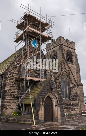 Au-dessus du porche, tour de l'horloge de l'église St. John's couverts d'échafaudages quand le travail de restauration est effectué - Baildon, West Yorkshire, Angleterre, Royaume-Uni. Banque D'Images