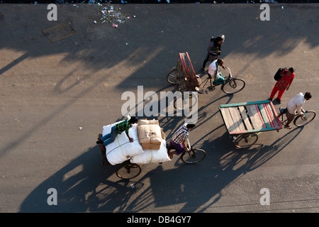Vue de dessus de pousse-pousse casting shadows sur la route comme ils transport des passagers le long des rues de Chittagong au Bangladesh Banque D'Images