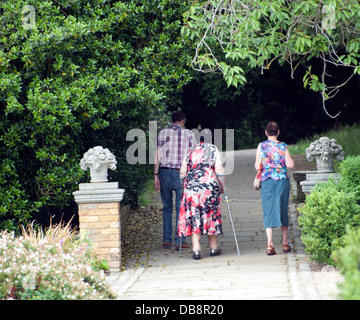 Diverses personnes âgées adultes matures walking in park homme adultes femmes adultes et fauteuil Banque D'Images