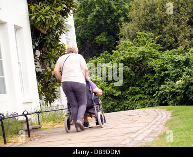 Diverses personnes âgées adultes matures walking in park homme adultes femmes adultes et fauteuil Banque D'Images