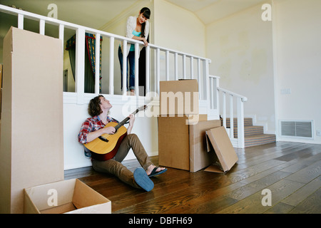 Couple relaxing in new home Banque D'Images