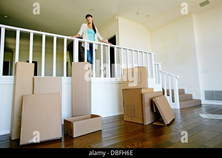 Mixed Race woman smiling in new home Banque D'Images