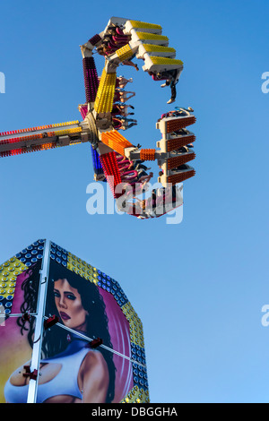 Thrillseekers excité / sensations fortes s'amusant sur le fairground attraction G Force à voyager fête foraine / se déplacer juste Banque D'Images