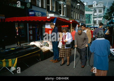 Marché français Sutton High Street Surrey homme âgé avec des bâtons de marche Banque D'Images