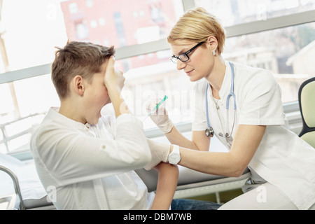 Femme médecin désireux de donner un coup de jeune garçon, Osijek, Croatie Banque D'Images