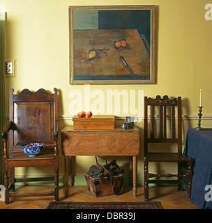 Peinture au-dessus d'une petite table et chaises en bois ancien maison en salle à manger Banque D'Images