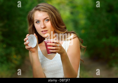 Belle fille de boire du café dans la nature Banque D'Images