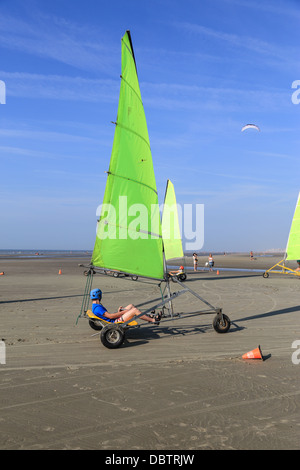 Les personnes conduisant le char à voile sur la plage. Ils sont en train d'apprendre et d'avoir du plaisir. Un homme roulant à l'avant-plan Banque D'Images