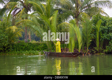 Une dame sur un bateau de pêche dans la rivière Thu Bon à Hoi An, Vietnam, Asie. Banque D'Images