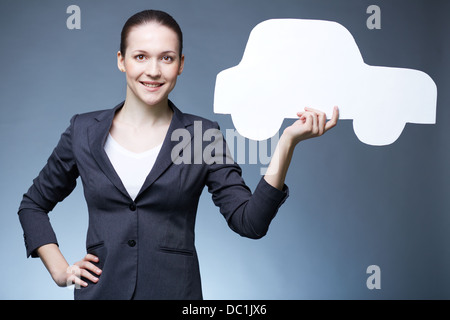 Portrait of young holding paper concessionnaire automobile et looking at camera Banque D'Images