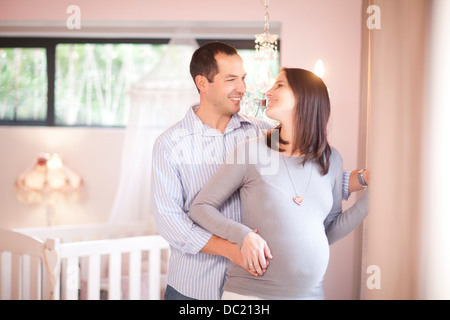 Expectant couple in nursery Banque D'Images