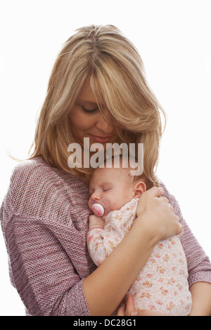 Mother holding newborn baby daughter