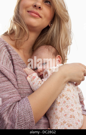 Mother holding newborn baby daughter