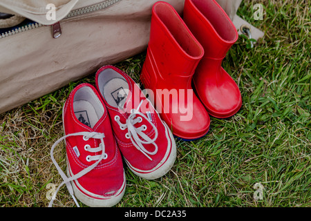 Espadrilles rouge et rouge à l'extérieur de welliingtons tente Banque D'Images