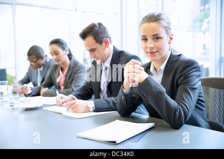 Portrait of smiling businesswoman in meeting Banque D'Images