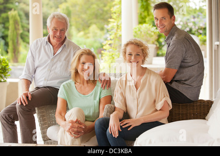 Portrait of smiling couples on patio Banque D'Images