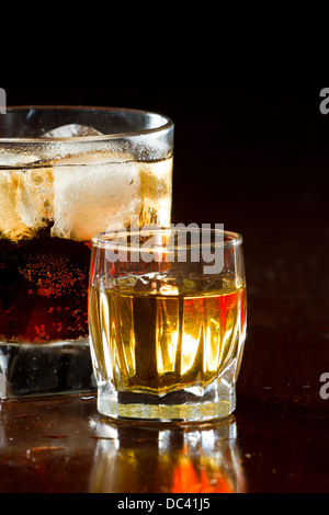 Cuba libre, Rhum et cola cocktail servi dans un verre court un shot de rhum sur le côté Banque D'Images